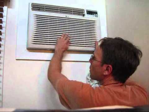 man repairing air conditioning unit